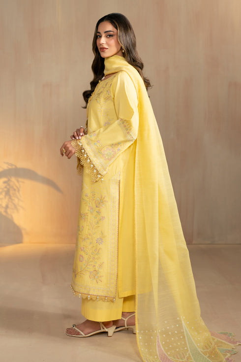 Side back view of Sheiza outfit showing flowing dupatta drape and shirt length, stitched yellow eastern wear for festive gatherings.