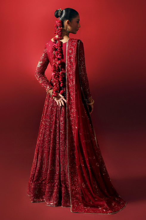 Side profile of NAQSHI Zilly red gown showing flowing panels, embroidered adda detail and sequin-embellished sleeve