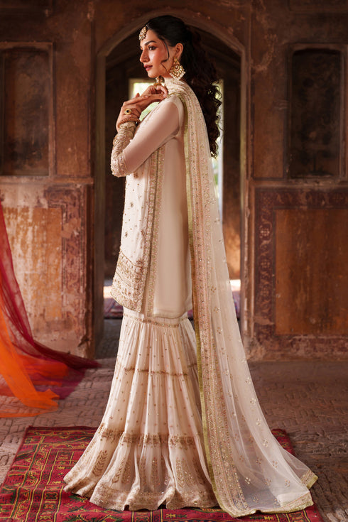 Woman in a traditional outfit with a decorative background
