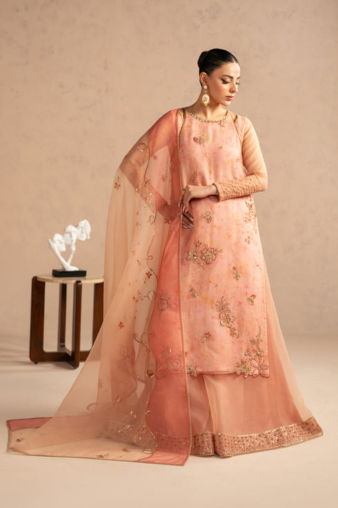 Side angle of Aysun outfit showing long modest fall, layered organza shirt with digital inner and bordered sharara, occasion wear dress.