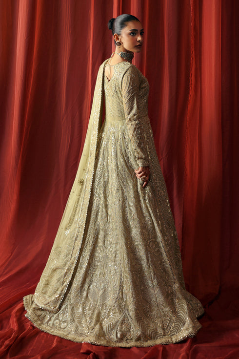 Side profile of NAQSHI Karishma pistachio gown showcasing flowing panels, intricate embroidery and structured sleeves