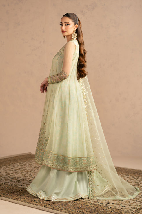 Front standing view showing wide flared frock fall with bordered hem and neat neckline detailing, elegant festive wear.