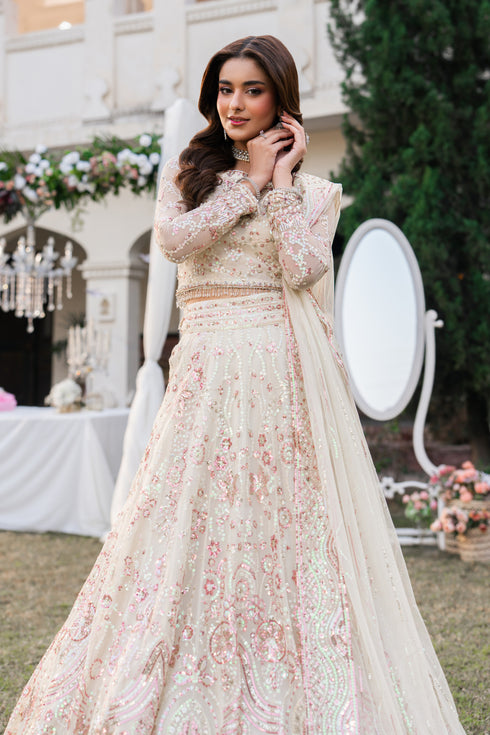 Woman in a floral dress standing outdoors with decorative elements in the background.