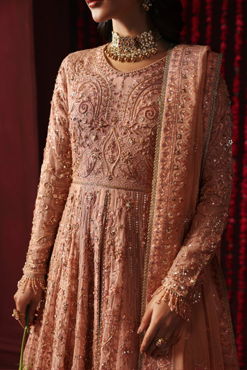 Model wearing NAQSHI Ashiayana peach 3-piece set: frock with embroidery, matching trousers and net dupatta