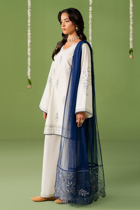 Side standing view of NAQSHI Kinza outfit highlighting relaxed culotte trousers and clean shirt silhouette