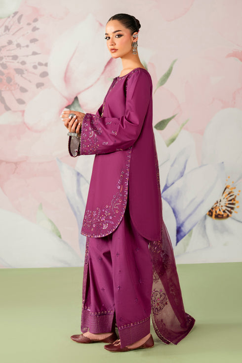 Woman wearing a traditional purple outfit with floral background