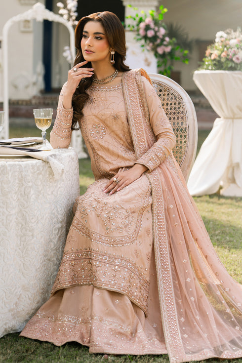 Talisa peach formal outfit shown from side with flowing sharara and soft net dupatta, event-ready traditional wear