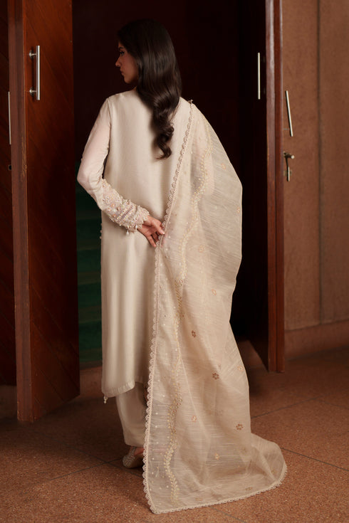 Back view of NAQSHI Minera dusty beige luxury pret outfit showcasing long flared khadi net shirt and elegant embroidered dupatta drape