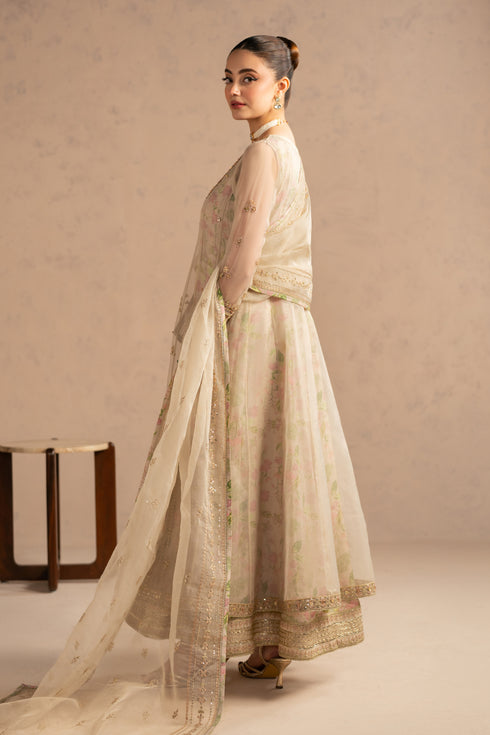 Side view showing wide flared frock panels and soft dupatta fall, elegant stitched formal wear.