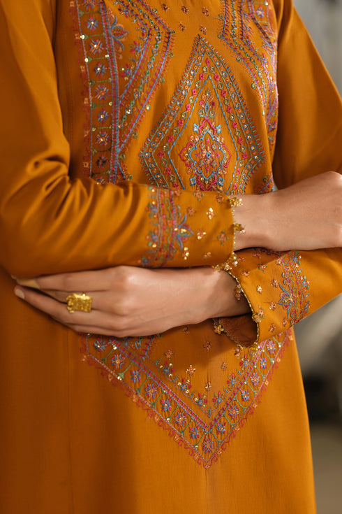 Close view of NAQSHI Ordhni rust Pima lawn shirt showing embroidered neckline and central front panel embroidery