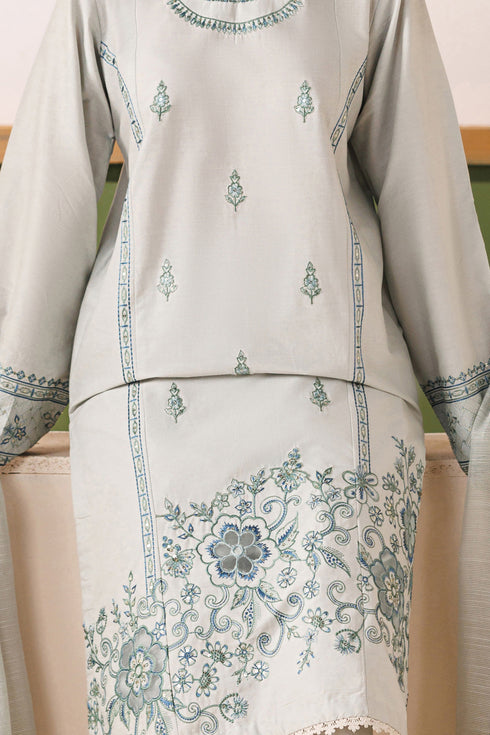 Close-up of NAQSHI Piper cambric shirt showing spread embroidery motifs and floral organza patch detail on the hem