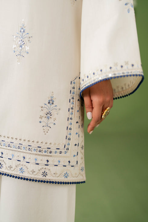 Close-up of NAQSHI Kinza sleeve and hem showing fine embroidery and neat border finishing