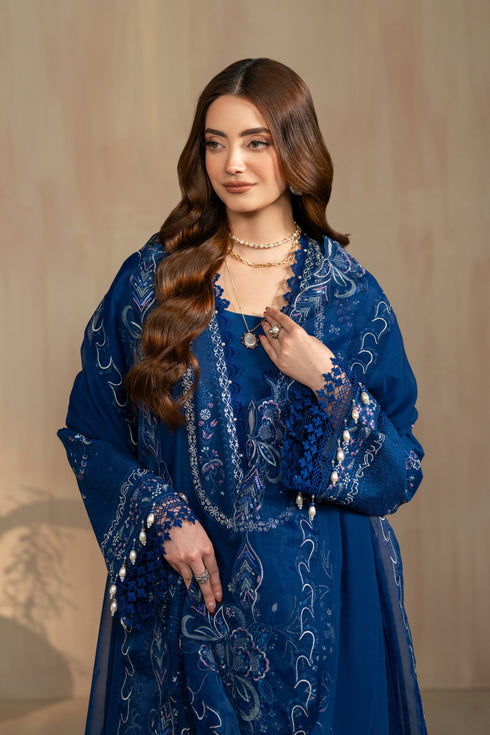 Front styling portrait highlighting embroidered neckline and sleeve borders of Atarah blue lawn dress, elegant ready made 3 piece outfit.