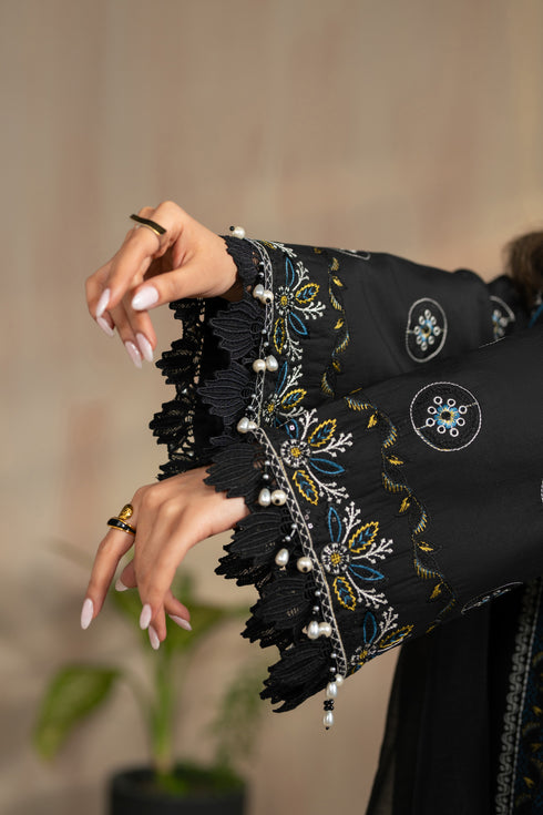 Close up of Hazeem sleeve embroidery and lace detailing with hanging accents, black lawn embroidered ready to wear suit.