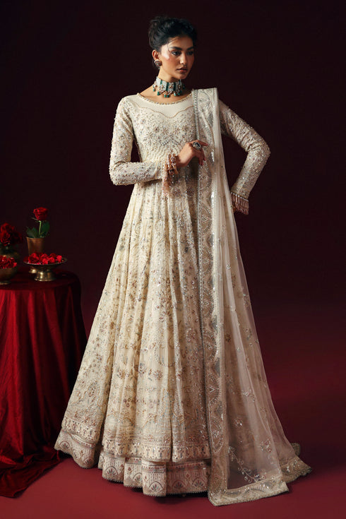 Model wearing NAQSHI Nurzaad 3‑piece off‑white ensemble with embroidered maxi and silk trousers