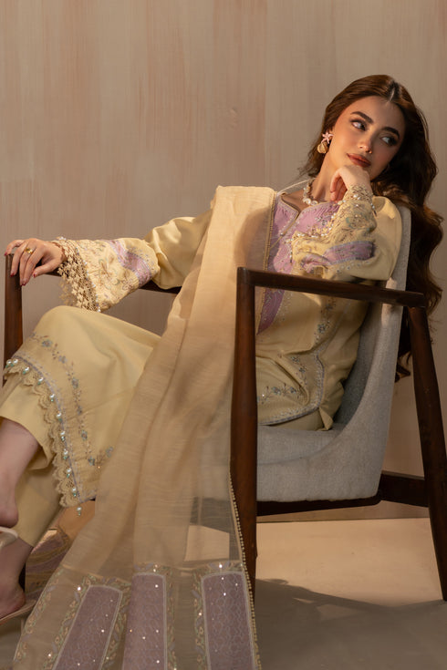 Seated styling pose of Nijah suit highlighting embroidered dupatta pallu and relaxed silhouette, elegant 3 piece ready to wear outfit.