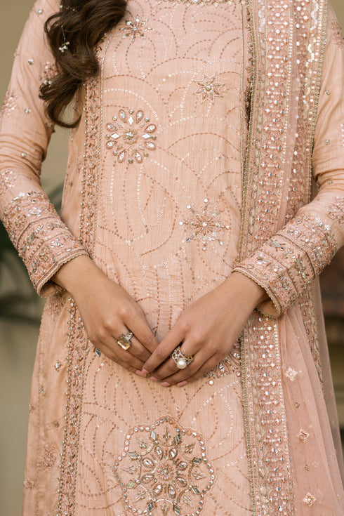Close-up of embroidery and sequin work on Talisa peach Indian raw silk shirt, fine detailing for formal wear