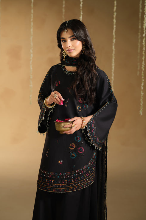 Close up of Lael sleeve and hem border embroidery detailing on black Pima lawn festive outfit