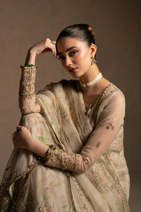 Close portrait showing neckline tassels, sleeve embroidery and delicate hand work details.