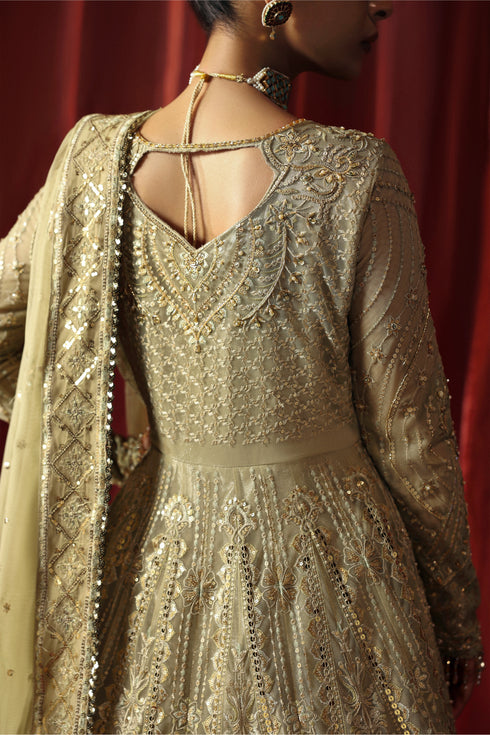 Model wearing NAQSHI Karishma 3-piece pistachio ensemble with embroidered frock, matching trousers and net dupatta