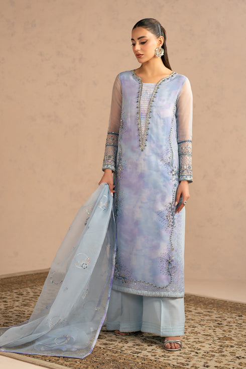 Walking pose showing movement of organza dupatta and soft layered shirt, elegant gathering wear dress.