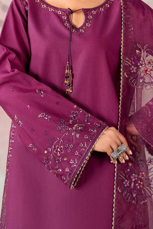 Purple embroidered outfit with intricate designs on a plain background
