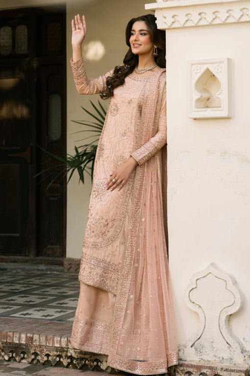 Talisa peach 3-piece raw silk outfit with wide-flare sharara and net dupatta, polished look for weddings and evening events