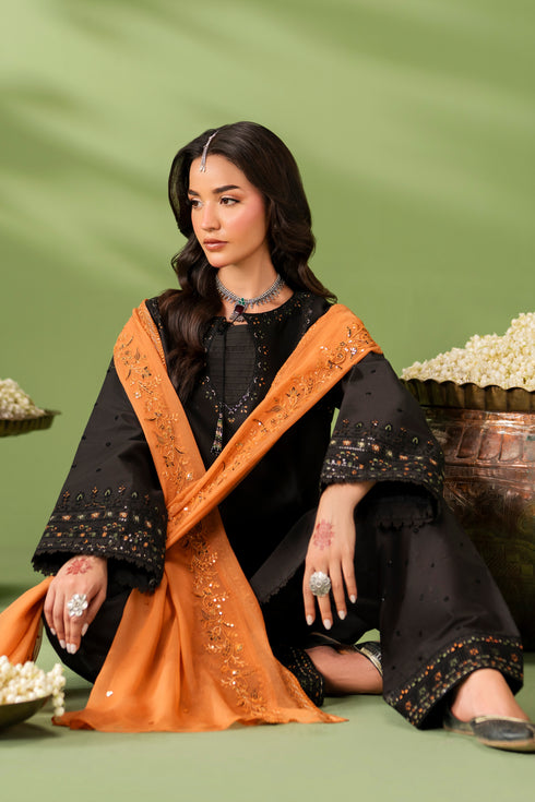Sitting styling view of NAQSHI Isma outfit showing crinkle dupatta drape and coordinated three-piece set