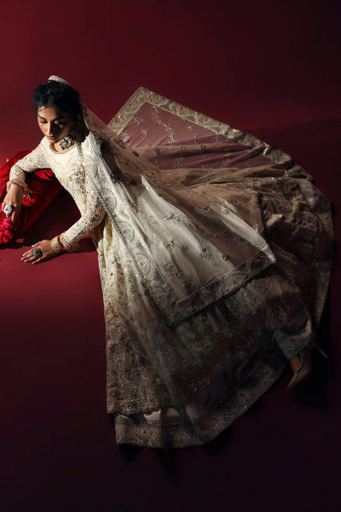 Model wearing NAQSHI Nurzaad 3‑piece off‑white ensemble with embroidered maxi and silk trousers