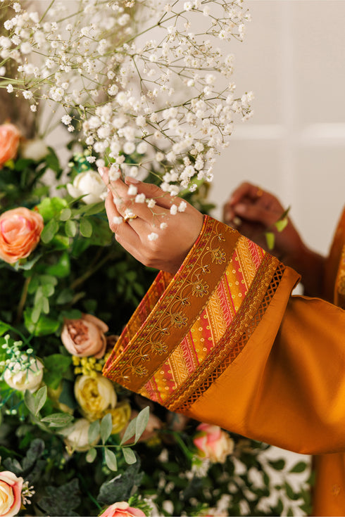 Close-up of NAQSHI Mohib sleeve and cuff showing embroidery, printed facing, and fine cotton satin finish