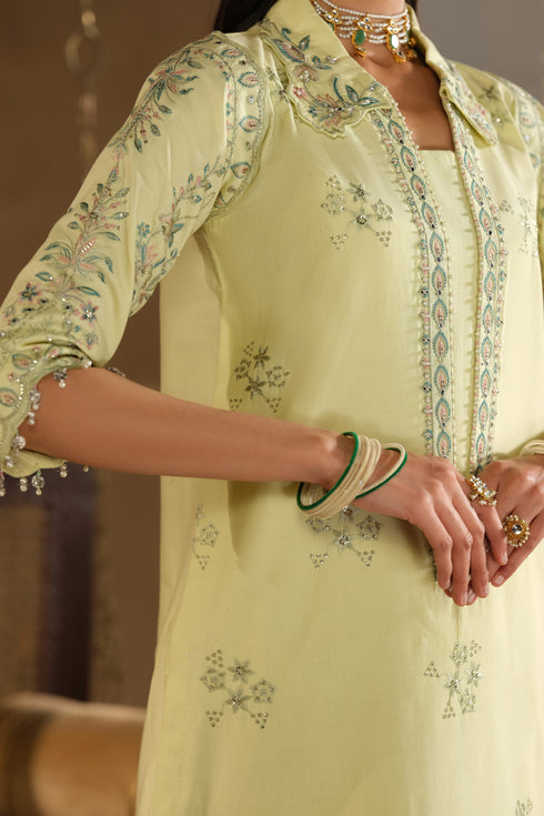Close up of Nagma shirt embroidery and sleeve cuff detailing on light lime Pima lawn fabric for soft festive wear