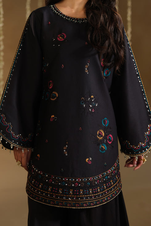 Close up of Lael shirt embroidery with floral and geometric patterns on black Pima lawn fabric