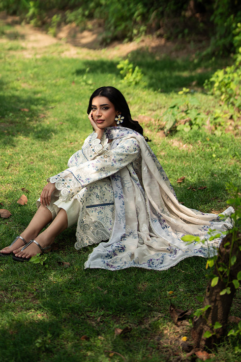 Sitting pose of Jaizah off white summer outfit showing straight cambric trouser and soft airy fabric for daytime wear