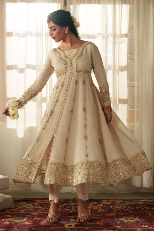 Model wearing full NAQSHI Rumi 3PC: intricately embroidered viscose frock with front slit, raw‑silk trousers & sequined organza dupatta for formal event styling