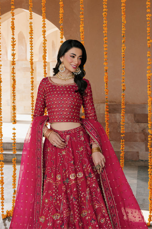 Model wearing full NAQSHI Nageen 3PC: hot‑pink embellished raw‑silk lehenga, sequin‑studded choli with side tassels & embroidered organza dupatta