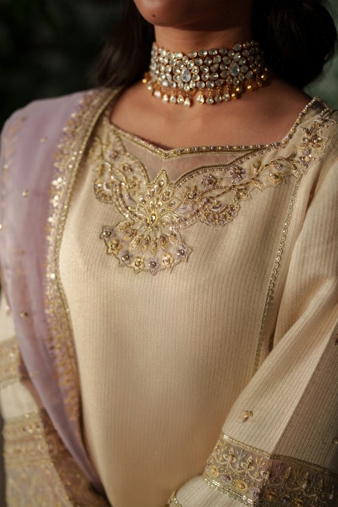 NAQSHI Kai close‑up of adda embroidery and thread embroidery on shirt sleeve cuff.