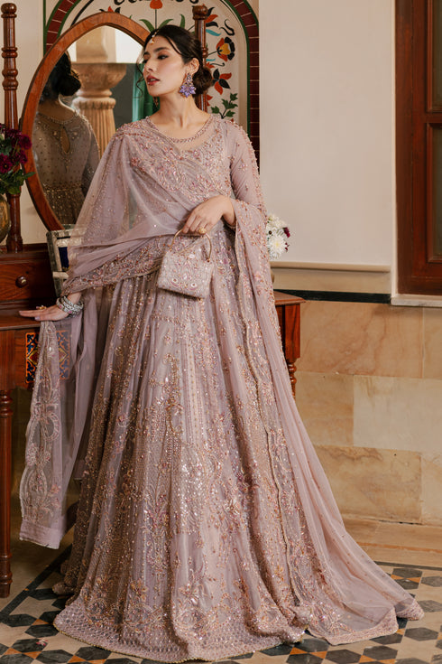 NAQSHI Nihan dusty‑lilac net maxi frock with boat neckline, sheer organza applique, heavy hand embellishments in stones, pearls & crystals across bodice