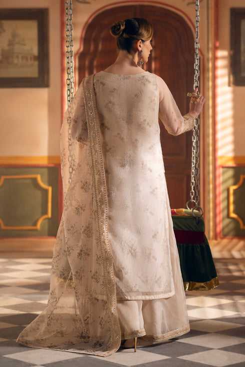 Back view of NAQSHI Shifa beige formal outfit showing layered organza shirt, detailed embroidery, and soft printed dupatta fall.