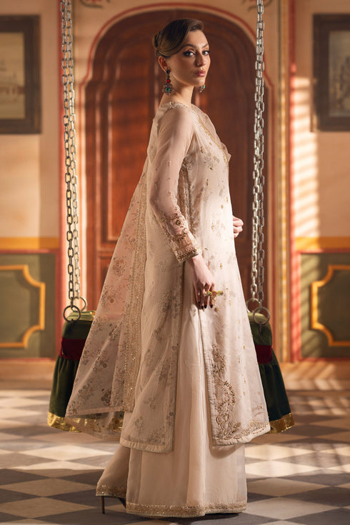 Side view of NAQSHI Shifa beige organza outfit showing layered shirt panels, fitted sleeves, and refined formal silhouette.