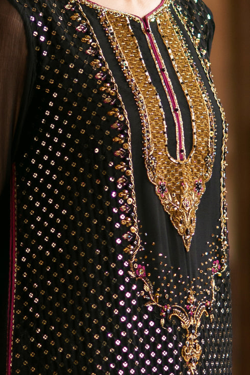 Close-up of embellished neckline with brown contrast applique detailing and sequins work on Irra black crinkle shirt