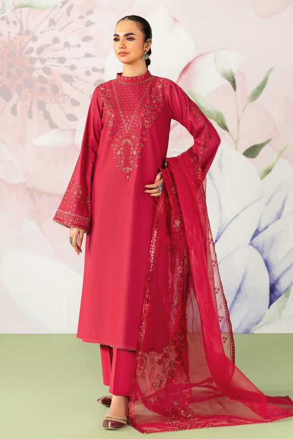 Woman wearing a red embroidered traditional outfit with a matching dupatta against a floral background