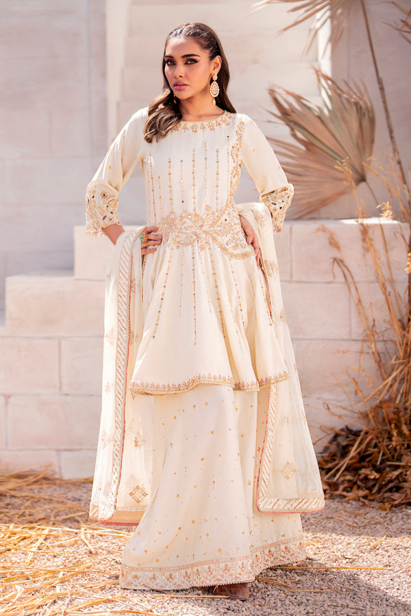 Naqshi Diana off‑white raw‑silk peplum shirt with boat neckline adorned in mirror work and naqshi dabka, paired with flared sharara and net dupatta.
