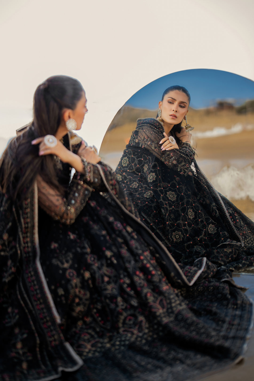 Side view of NAQSHI Blain showcasing fluid frock silhouette, detailed sleeve-end crystal hangings, richly composed embroidered panels, and floor‑length cutline.