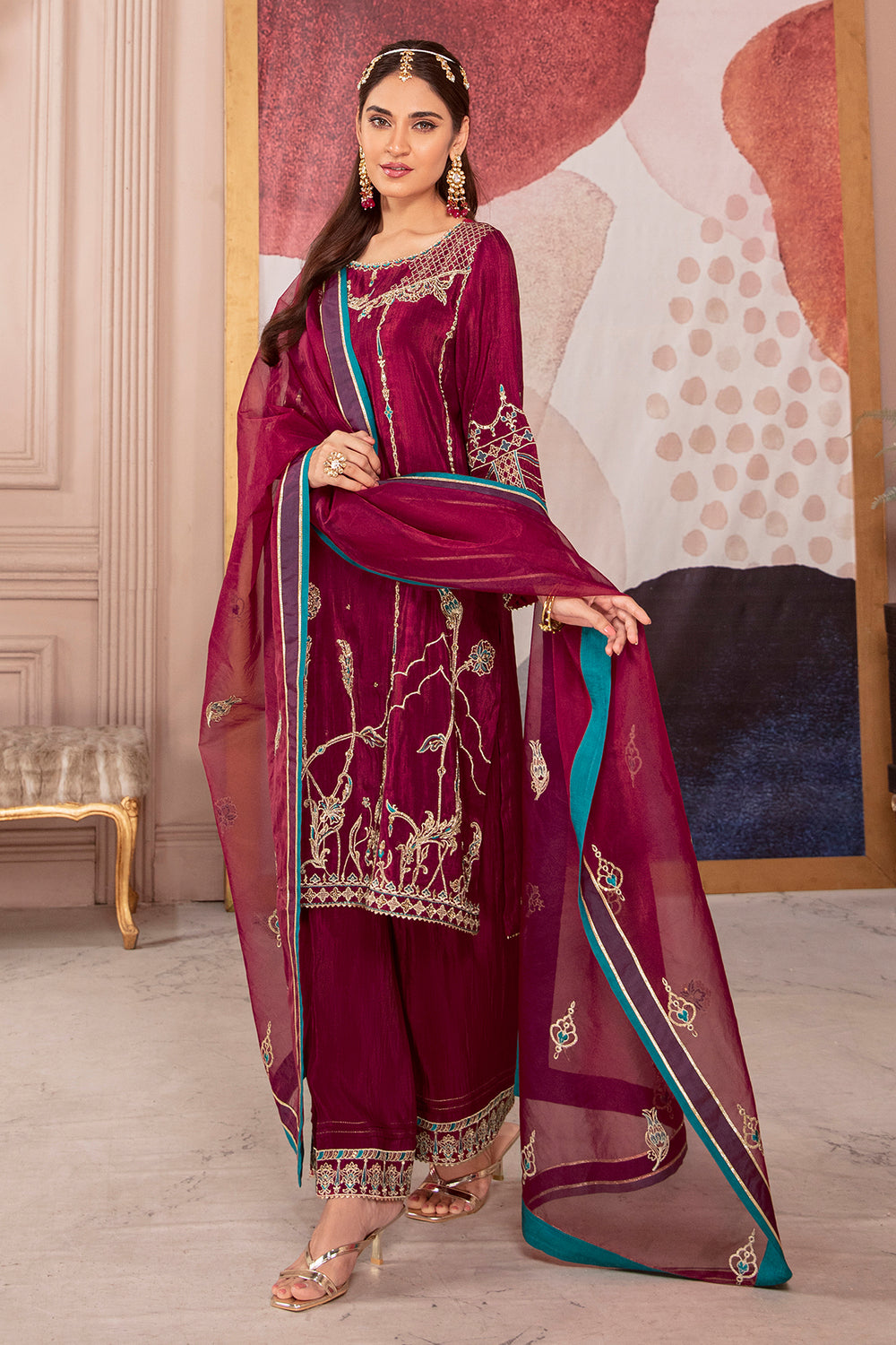Standing pose of Erina burgundy pink dress showing flowing long shirt and culottes with embroidered borders, elegant ready made festive outfit.