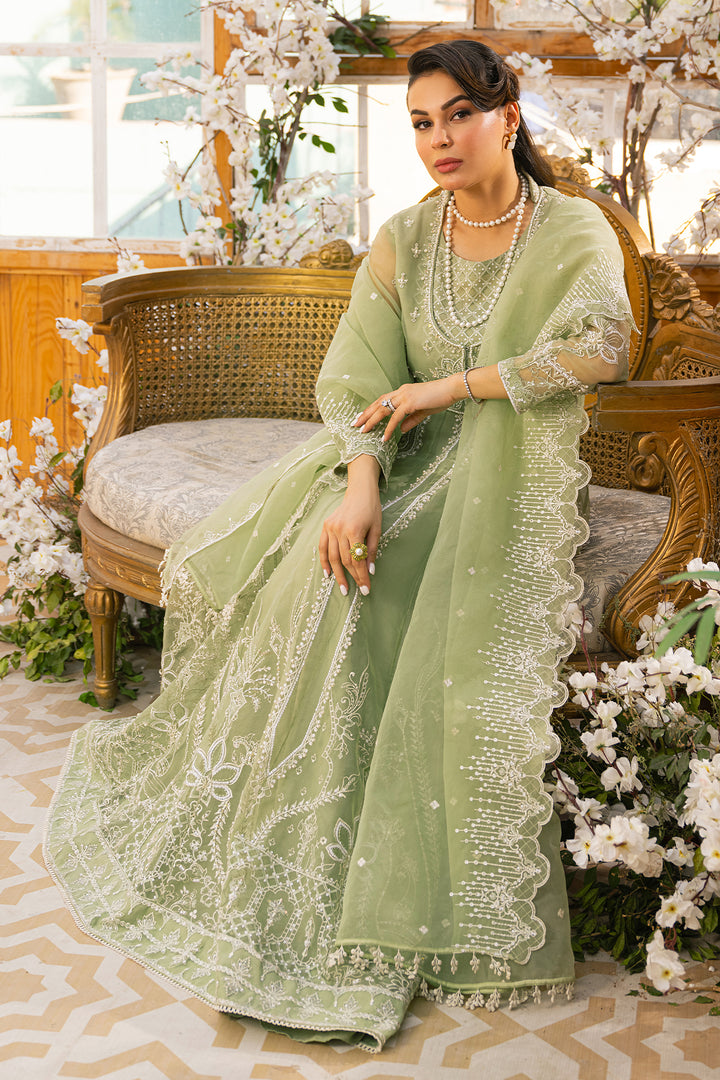 Seated side portrait of Ayla pistachio outfit showing soft layered fall and coordinated styling, traditional ready made festive attire.