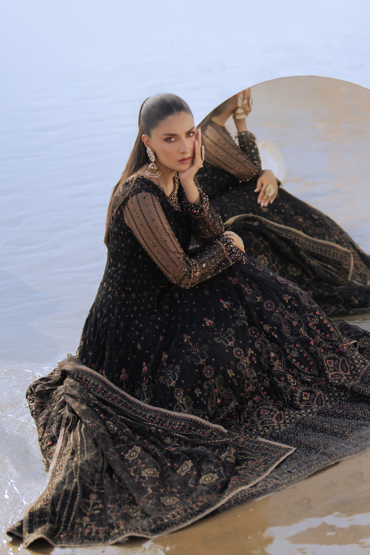 Model wearing full NAQSHI Blain set: black embellished net frock, plain straight PK raw‑silk pants, ornate dupatta with heavy embroidery &amp; tassels.