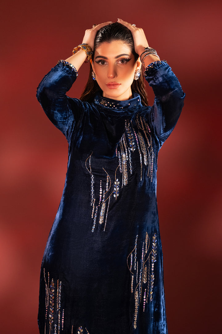 Front portrait of neon blue velvet dress focusing on ban neckline embellishment and stone work, elegant ready to wear formal attire.