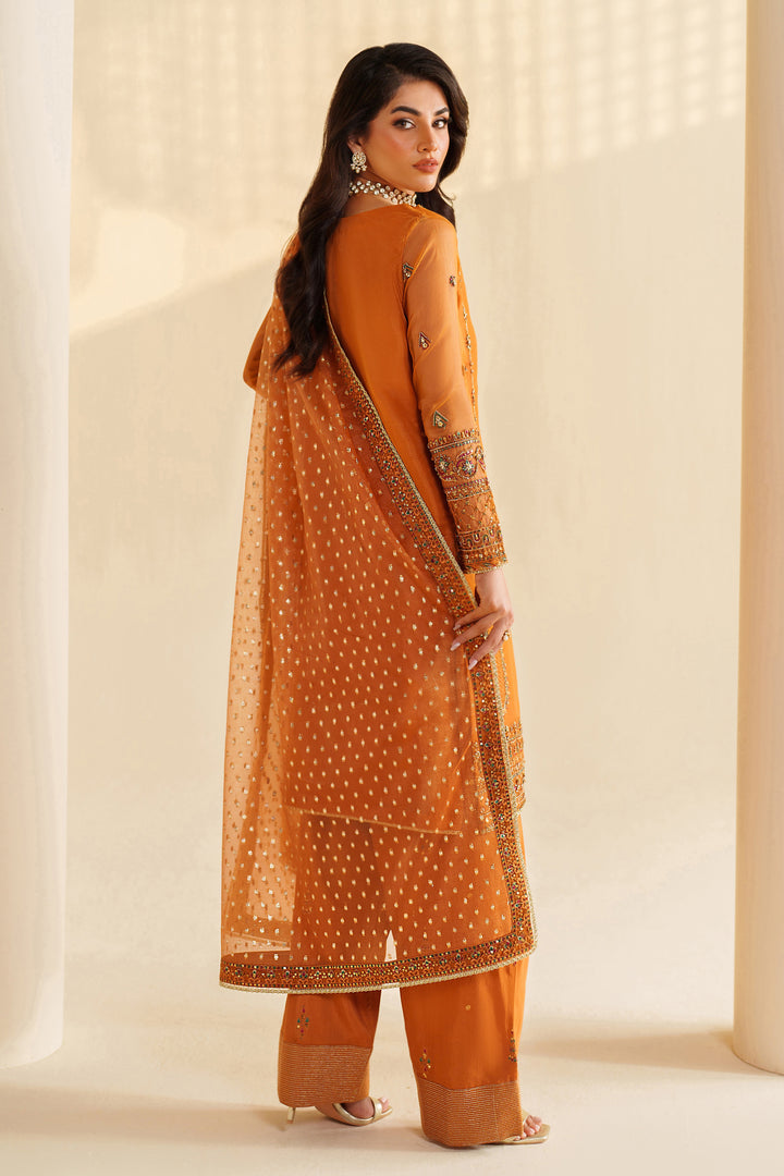 Back view of NAQSHI burnt orange formal ready-to-wear outfit showing straight fall, embroidered borders, and event-ready finish