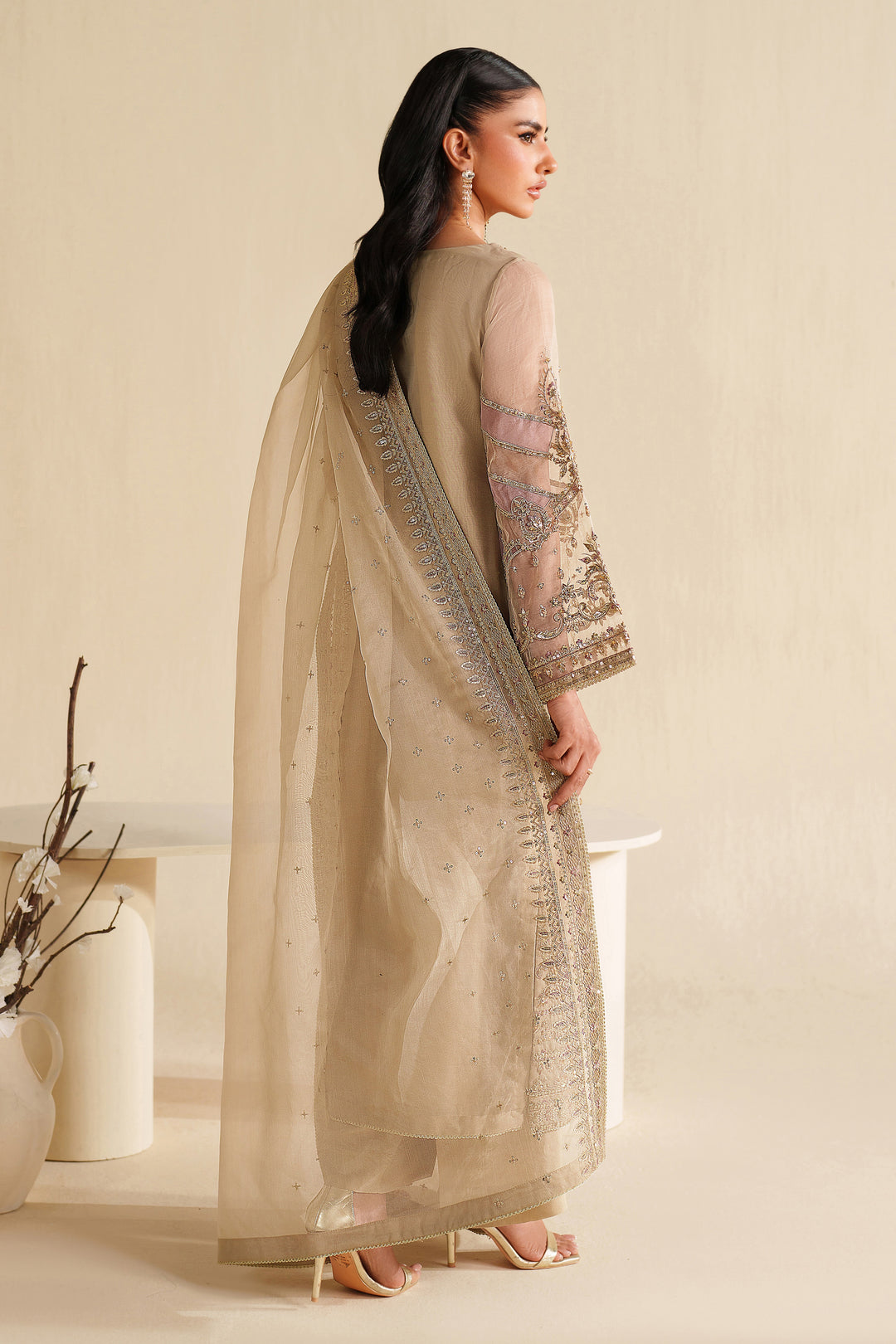 Side view of NAQSHI ivory beige formal ready-to-wear outfit showing straight cut, light embroidery, and polished event finish