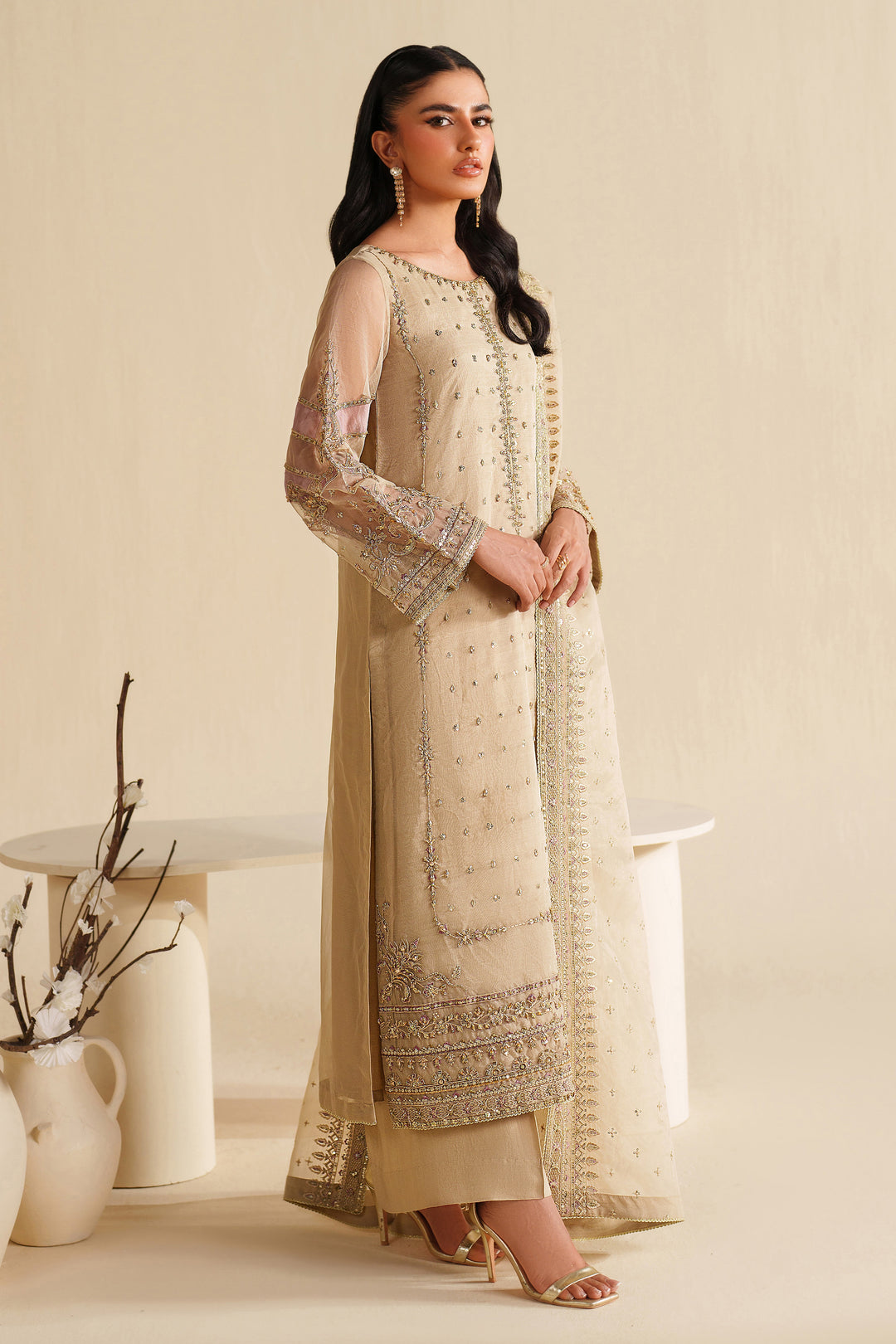 Side view of NAQSHI ivory beige formal ready-to-wear outfit showing straight cut, light embroidery, and polished event finish